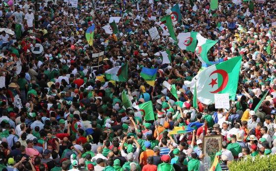 Celebrating arrests, but still pushing for change, protesters rally in Algeria