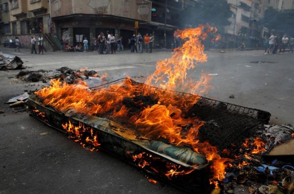 Venezuelans set up burning barricades over lack of power, water