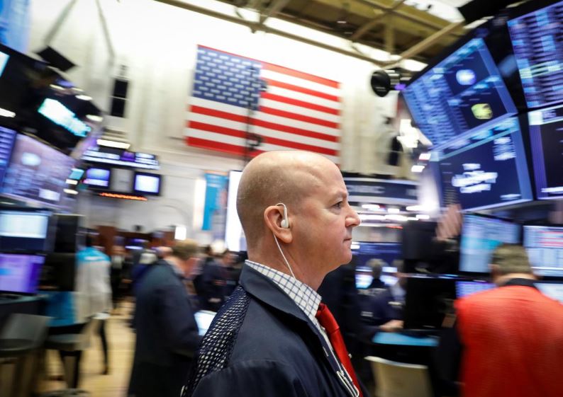 Gold jumps, stocks trade erratically after Fed's rate cut