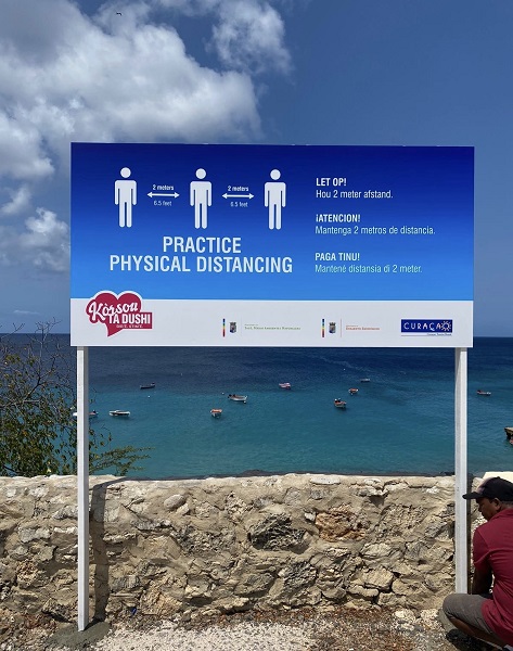 Signage with message to maintain physical distance